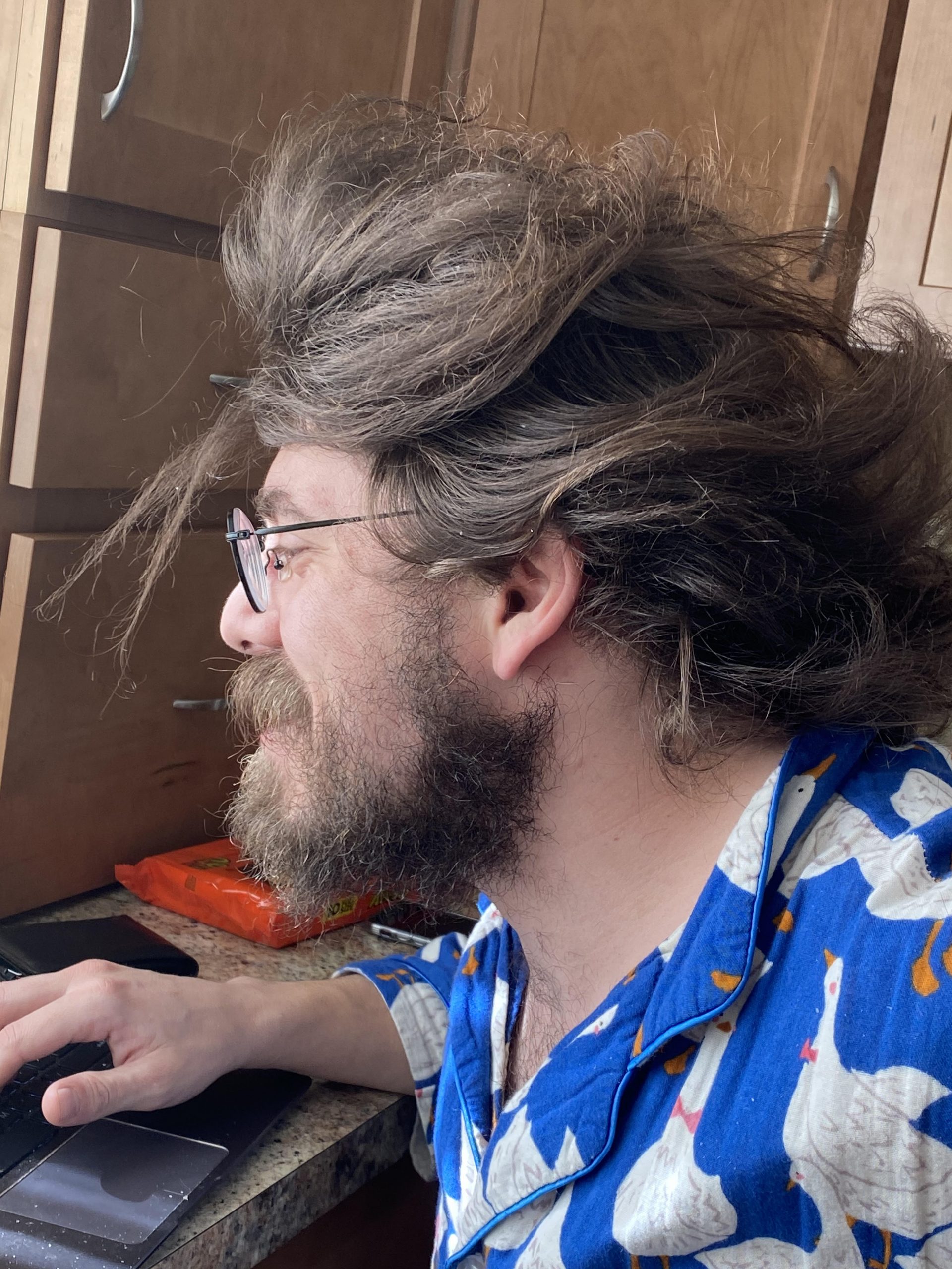 Charles Baird coding in the kitchen.
