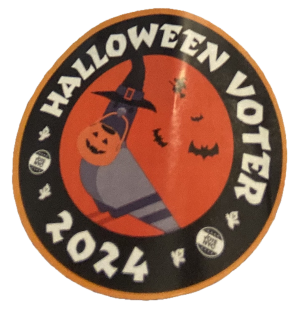 A sticker that says Halloween
Voter 2024. In the middle, there is a picture of a pigeon, wearing a witch&rsquo;s
hat and holding a pumpkin trick-or-treat basket in its beak, while bats
and such fly around in the background.